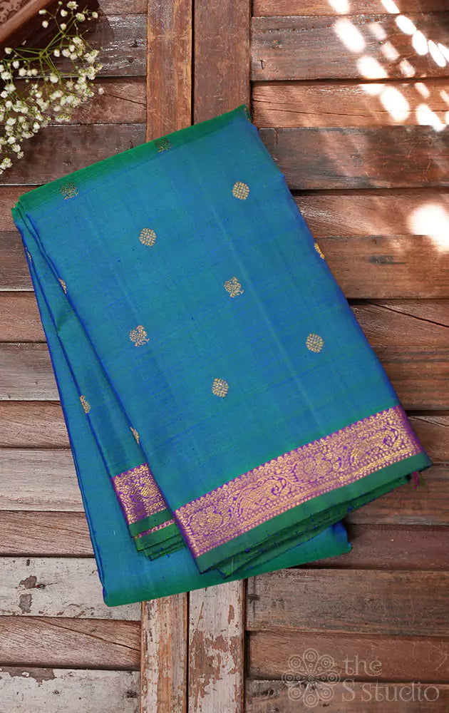 Peacock blue kanchi pattu saree with purple pallu