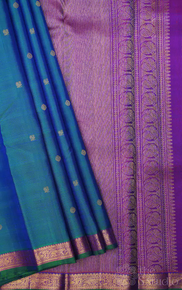 Peacock blue kanchi pattu saree with purple pallu