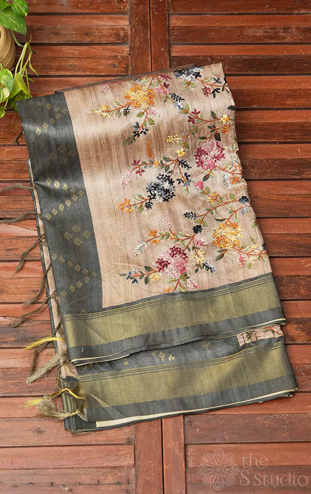 Beige semi tussar saree with floral embroidery on pallu