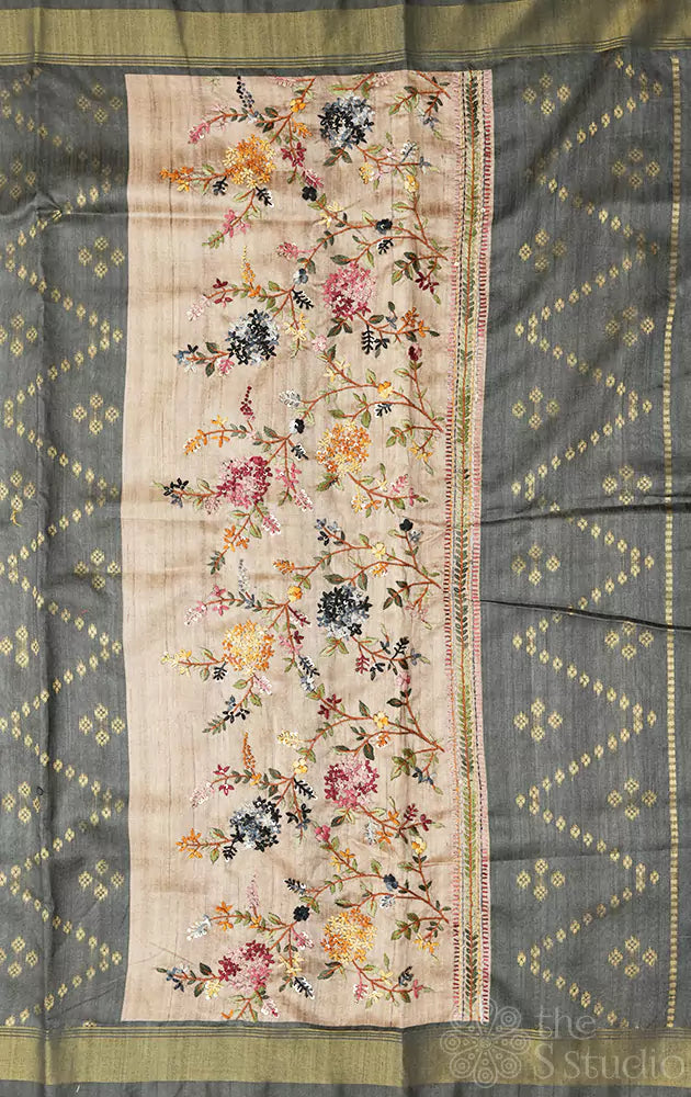 Beige semi tussar saree with floral embroidery on pallu