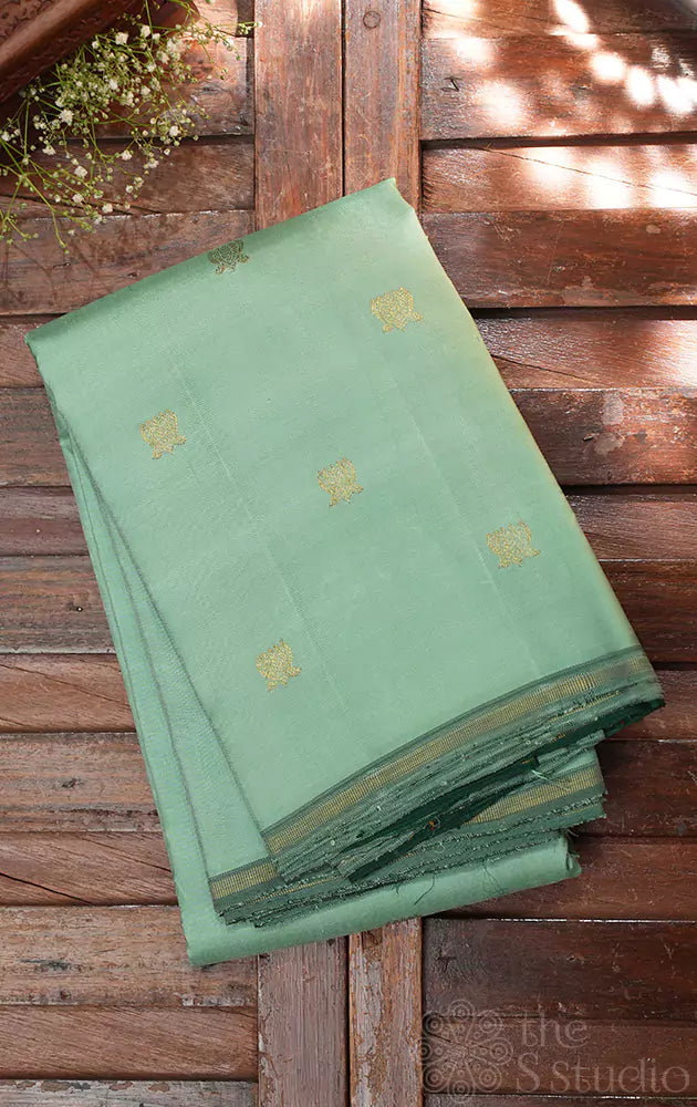 Pale green lotus butta kanchi silk saree with dark green pallu