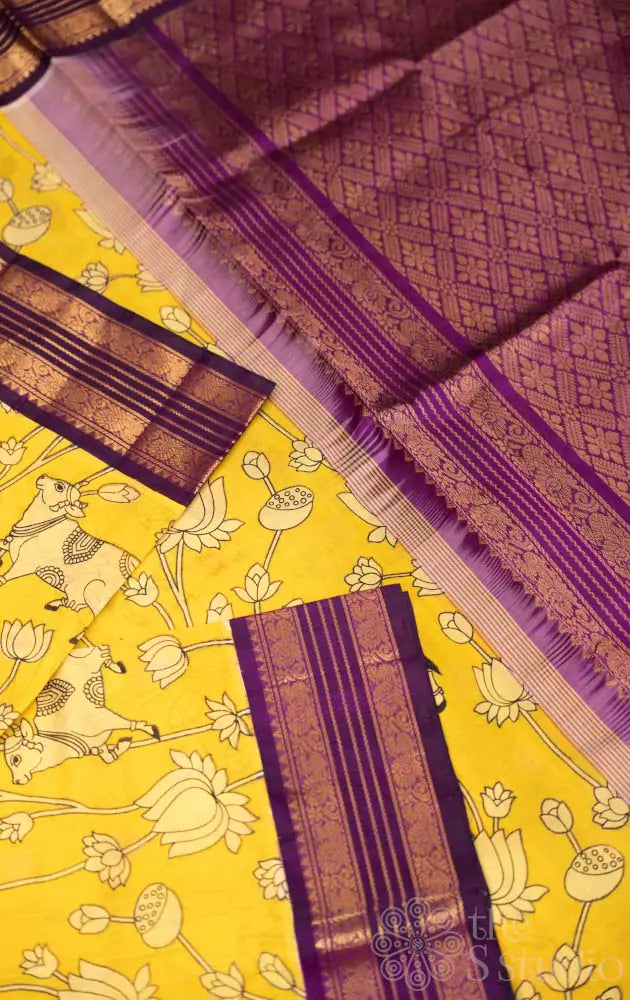 Lemon yellow silk cotton saree with pichwai prints & korvai border