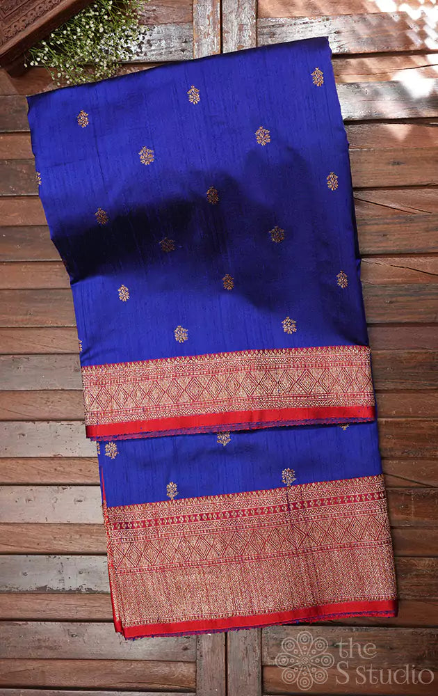 Blue raw silk saree with small zari buttas and contrast red border