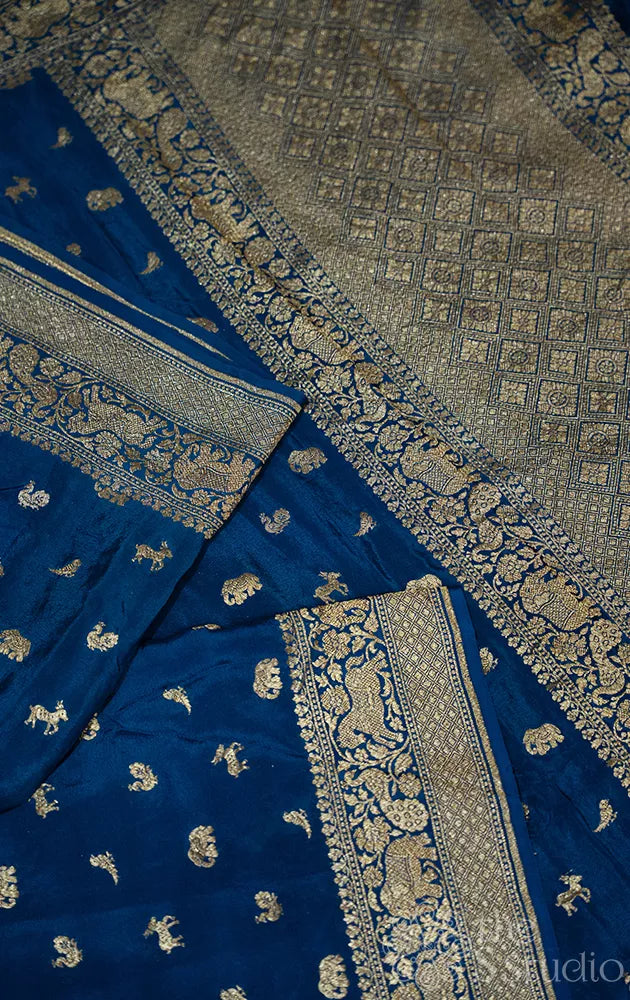 Peacock blue crepe banarasi silk saree with antique zari buttas