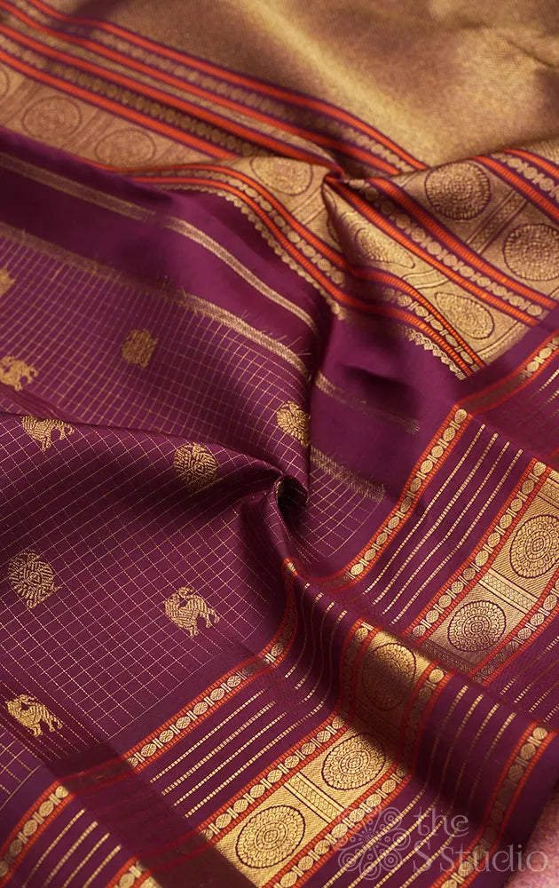 Brown zari checked kanchipuram silk saree with yazhi and peacock motifs