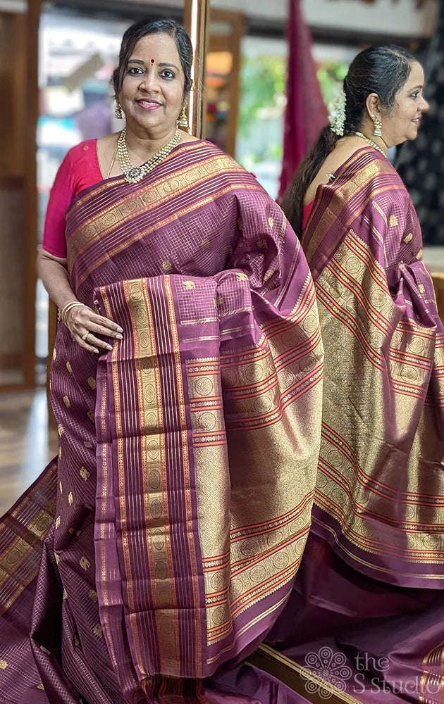 Brown zari checked kanchipuram silk saree with yazhi and peacock motifs