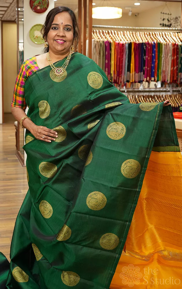 Bottle green kanjivaram silk saree with mustard pallu