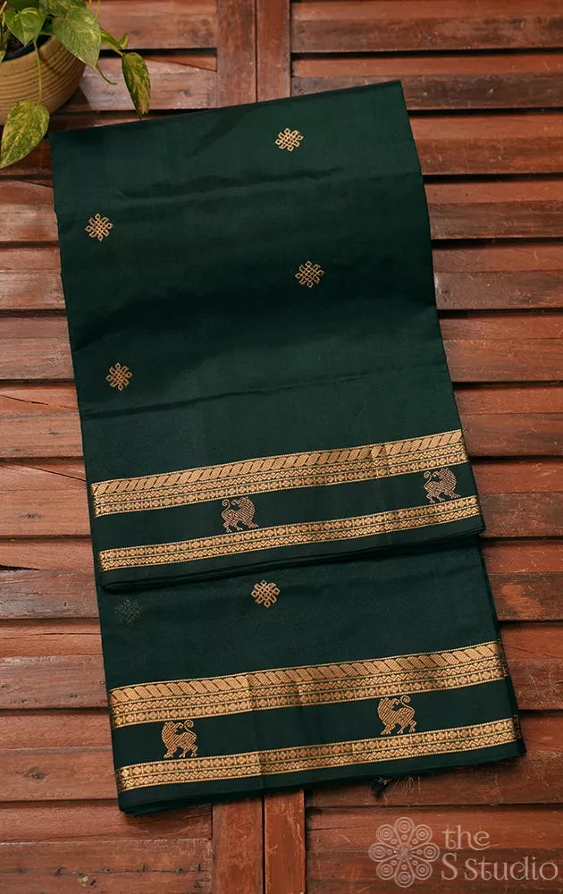 Bottle green silk cotton saree with rettai pet border ( image looks like brown. Please colour correct the image if it is bottle green)