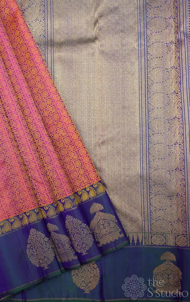 Peachish orange kanjivaram silk saree with a peacock blue border