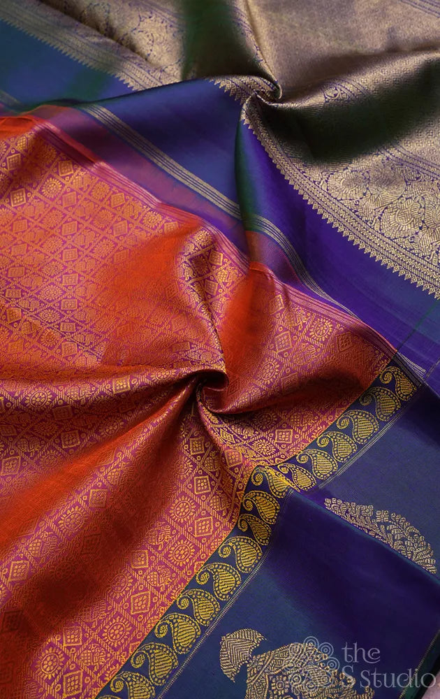 Peachish orange kanjivaram silk saree with a peacock blue border