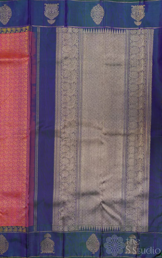 Peachish orange kanjivaram silk saree with a peacock blue border