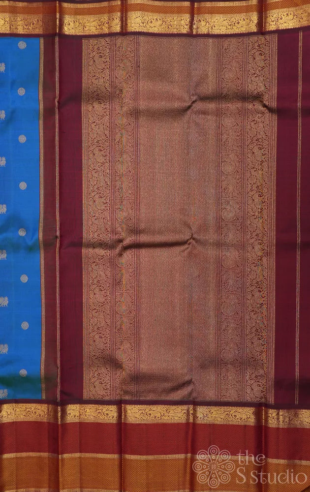 Peacock blue kanchipuram silk saree with maroon korvai border