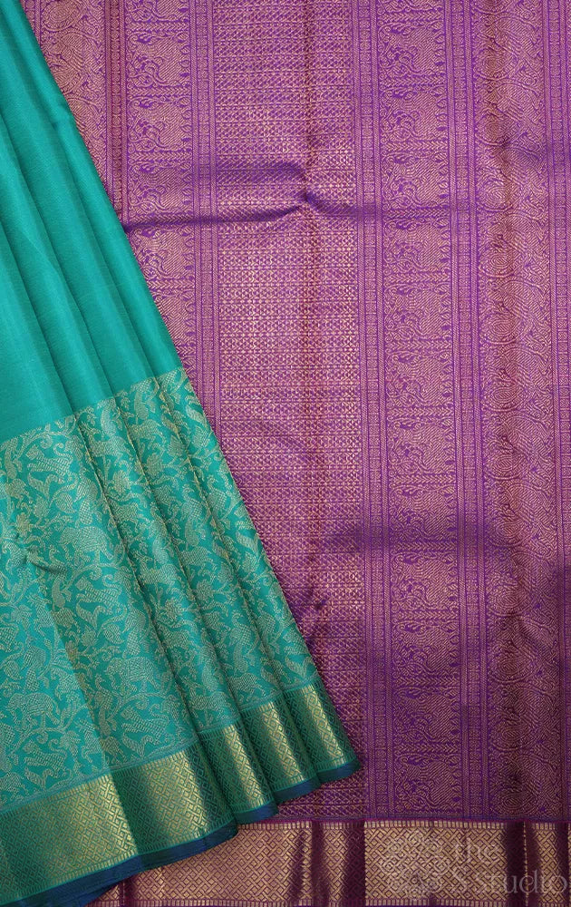 Bluish green kanchi silk saree with vanasingharam design and getti border