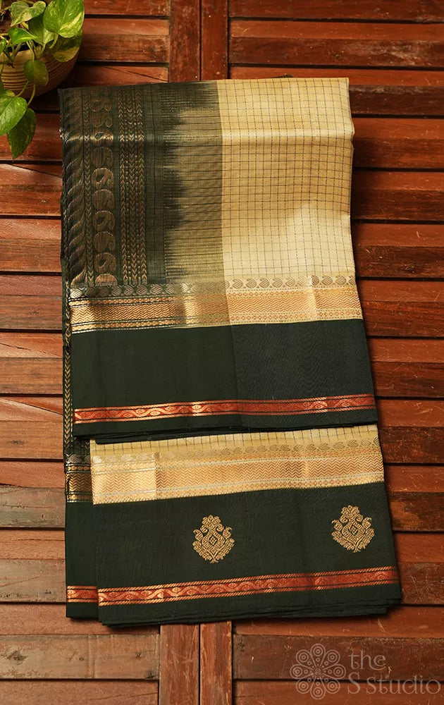 Cream colour checked silk cotton saree with dark bottle green korvai border