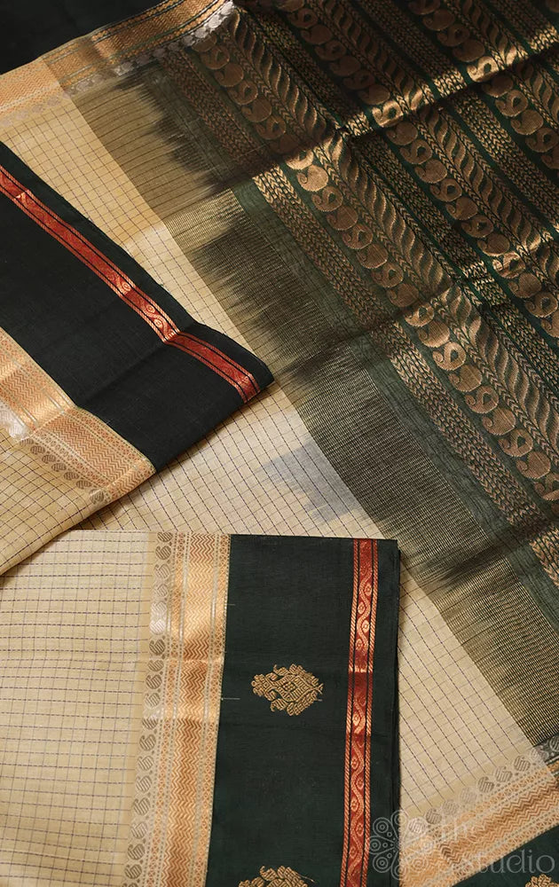 Cream colour checked silk cotton saree with dark bottle green korvai border