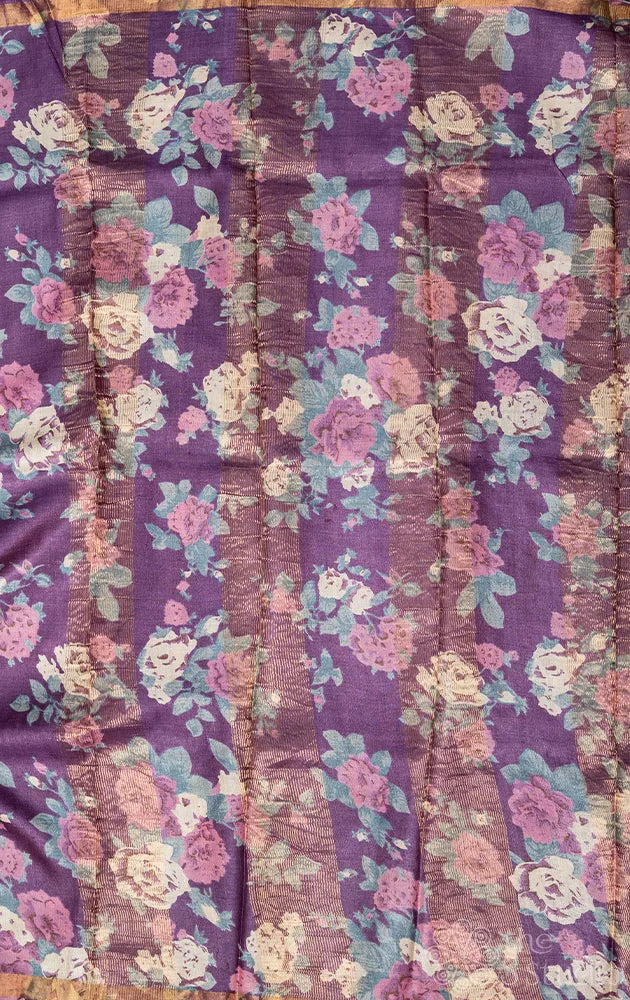 Grey tussar silk saree with purple floral prints on the border
