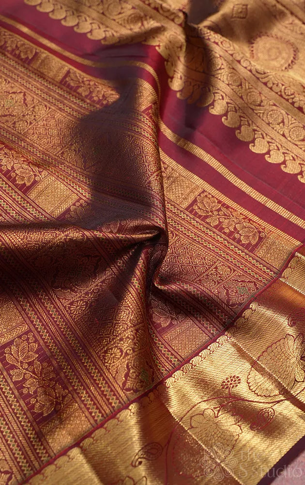 Dark arakku colour kanjivaram silk saree with floral zari border