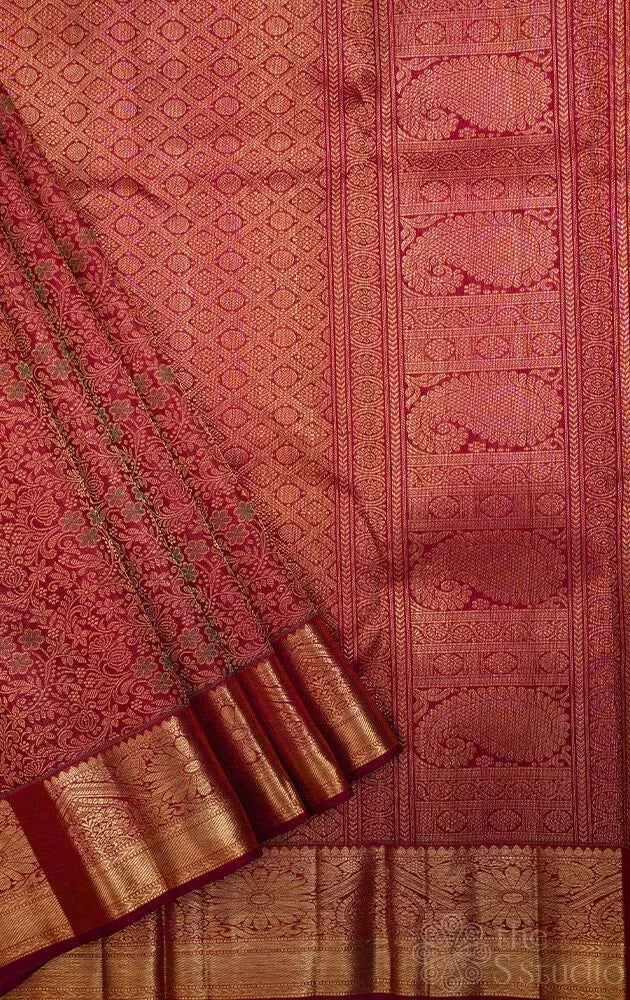 Maroon kanjivaram silk saree with all over floral meenakari motifs and grand border