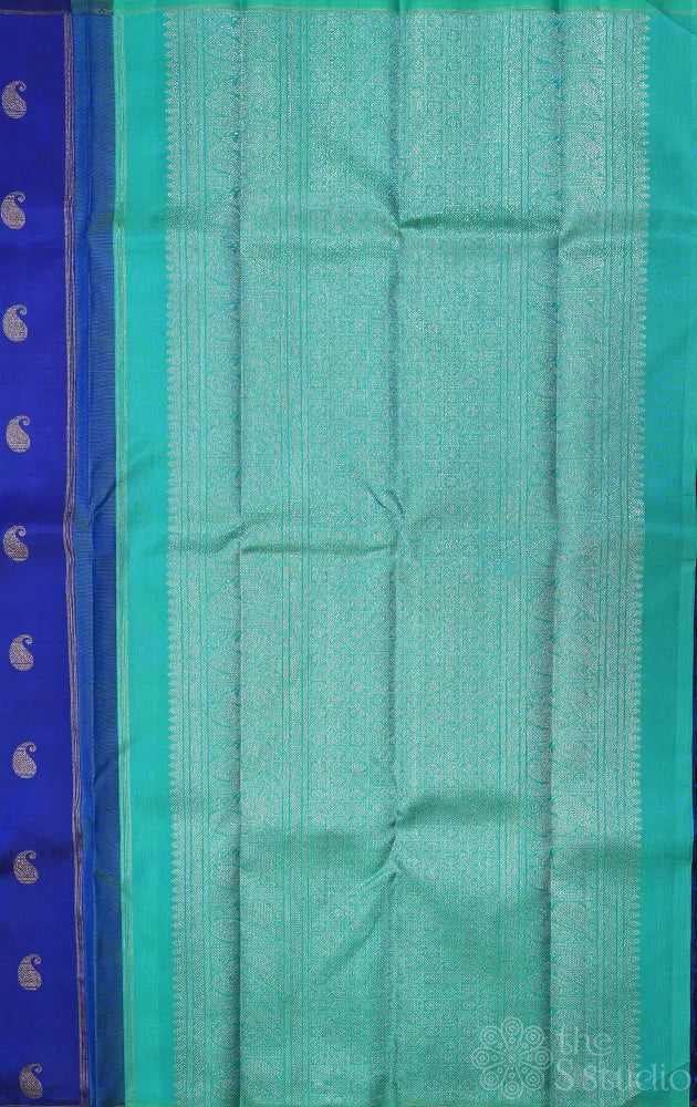 Royal blue kanchi pattu saree with paisley motifs and sea green pallu