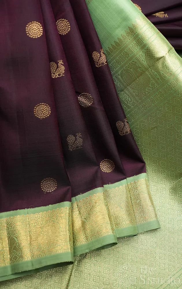Dark brown korvai kanchipuram silk saree with small elachi green border