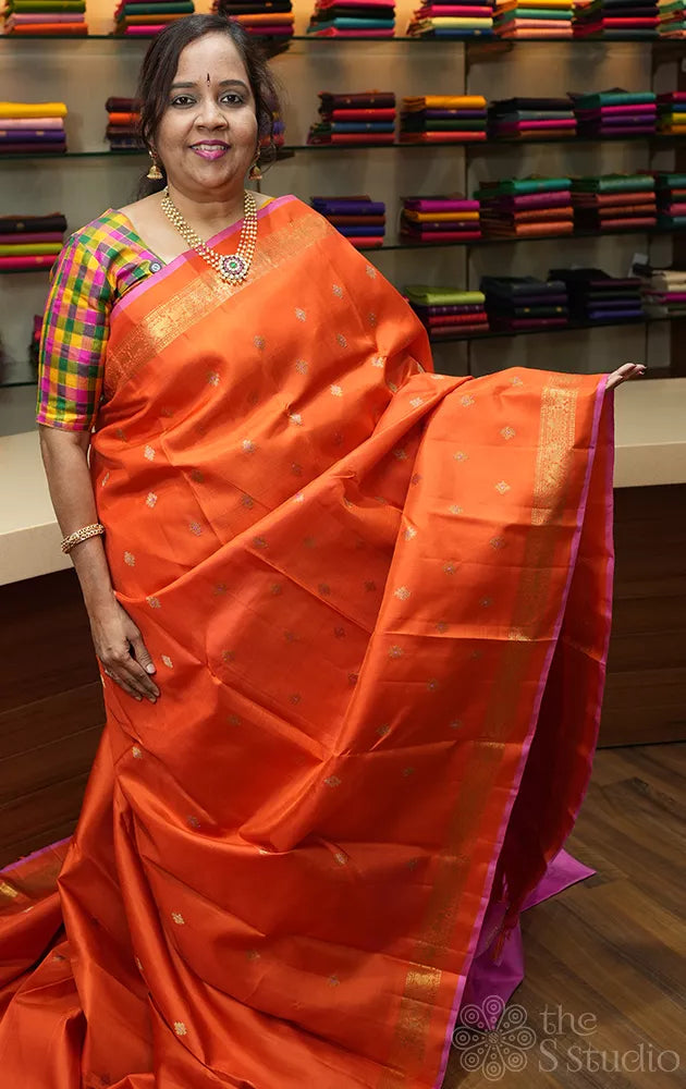 Orange kanchipuram silk saree with meena buttas