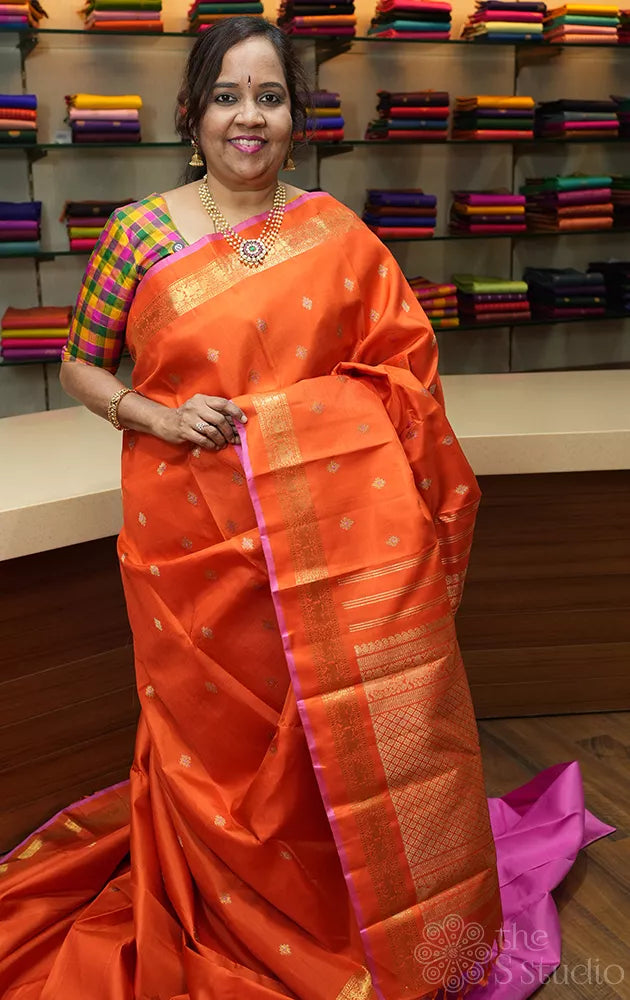 Orange kanchipuram silk saree with meena buttas