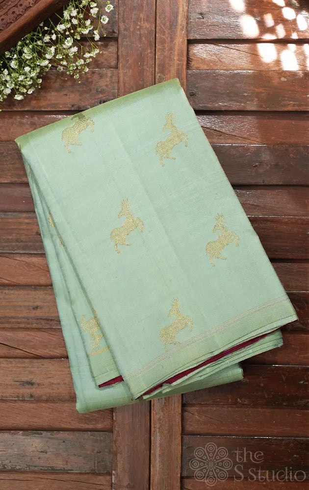 Elaichi green Kanjivaram silk saree with deer zari buttas and contrast pallu