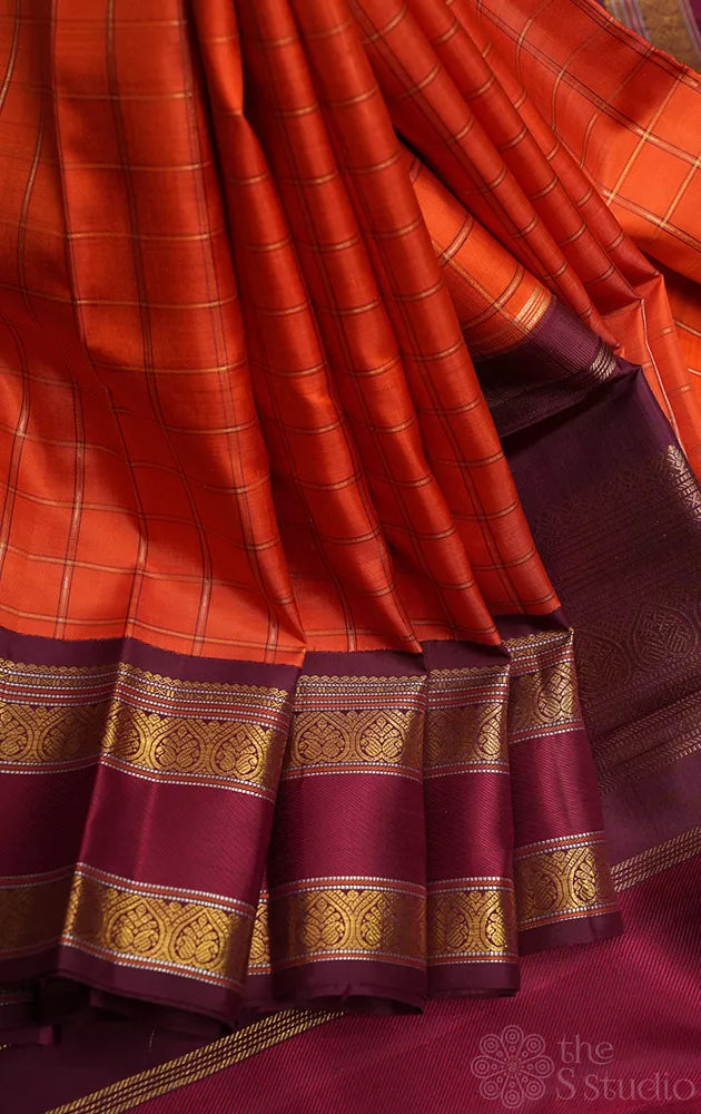 Orange kanjivaram silk saree with zari checks and korvai brown border