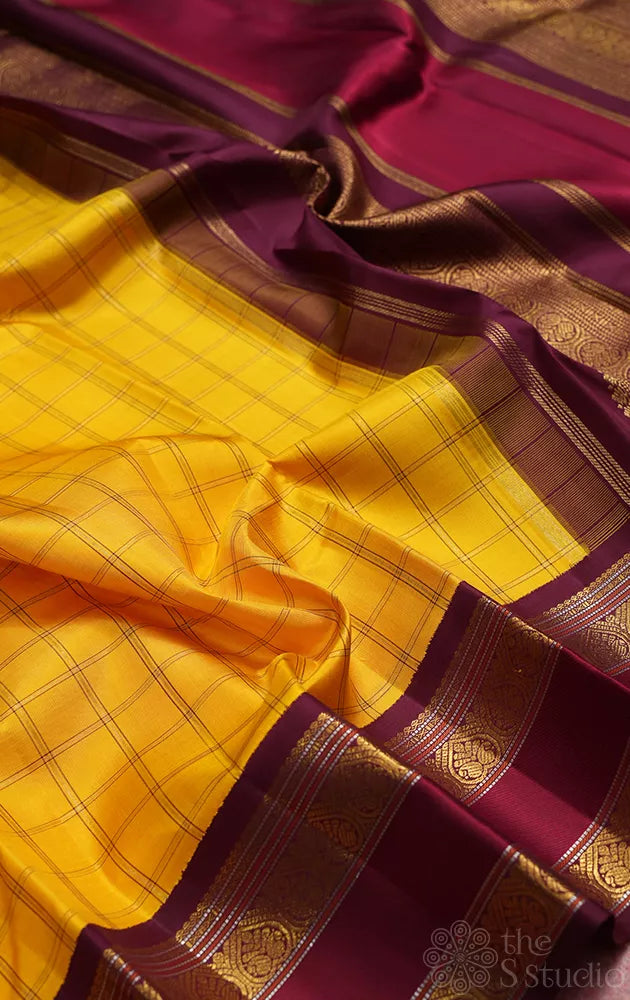 Yellow kanjivaram silk saree with zari checks and korvai brown border