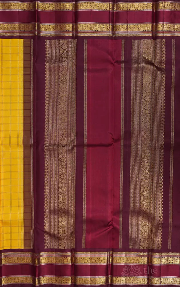 Yellow kanjivaram silk saree with zari checks and korvai brown border