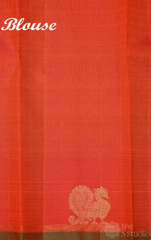 Rust orange kanchi silk saree with peacock motifs along the border