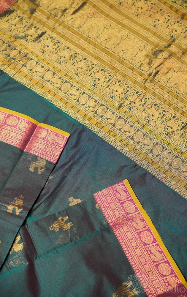 Teal green handloom kanchi cotton saree with deer butta and magenta border.