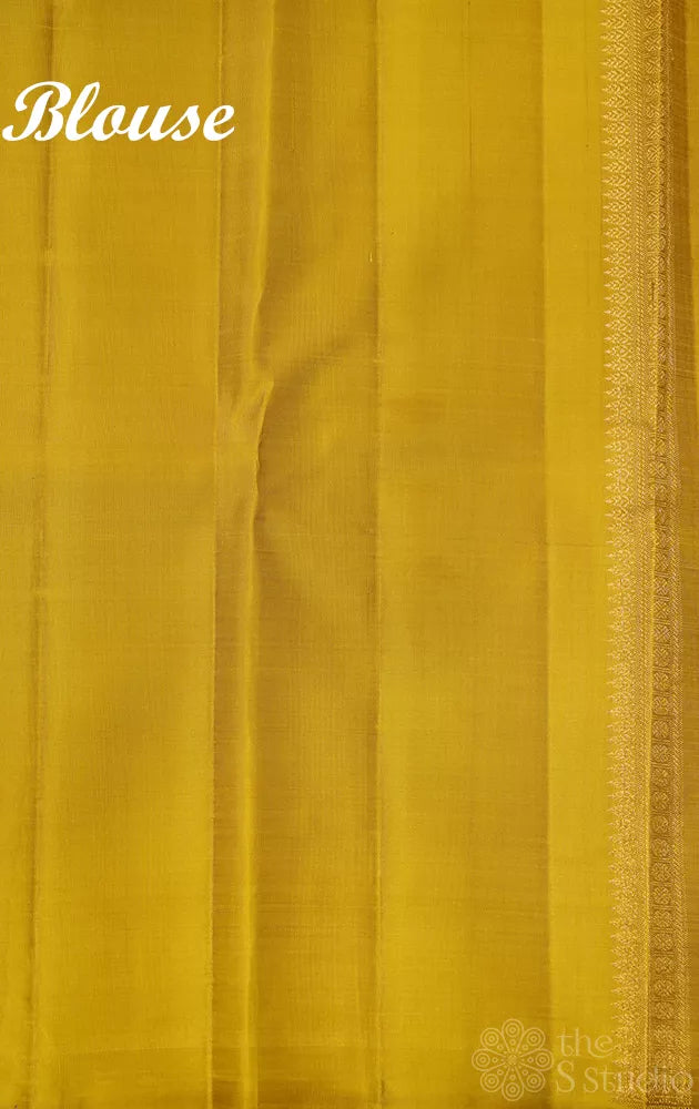Golden beige kanjivaram silk saree with thread buttas and a zari pallu
