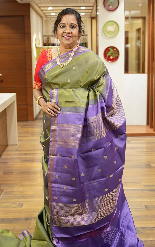 Olive green kanchi pattu saree with lavendar border and pallu