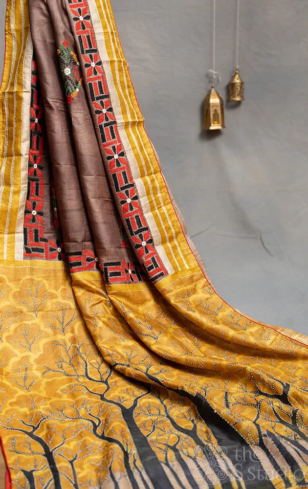 Brown and mustard hand embroidered tussar silk saree with hand batik prints