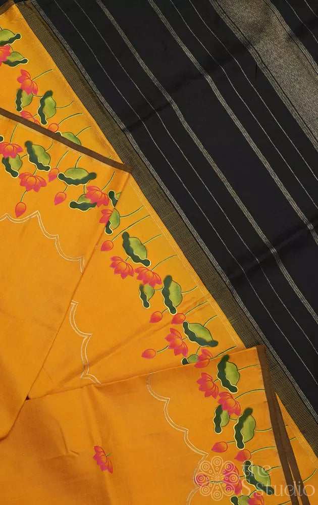 Mustard kanchipuram silk saree with hand painted pichwai and a black pallu
