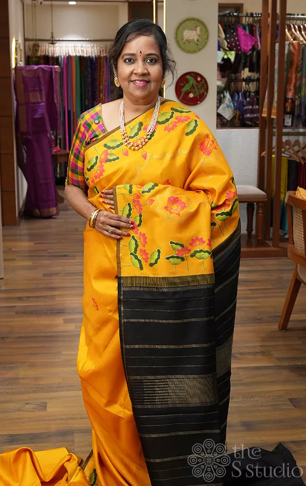 Mustard kanchipuram silk saree with hand painted pichwai and a black pallu