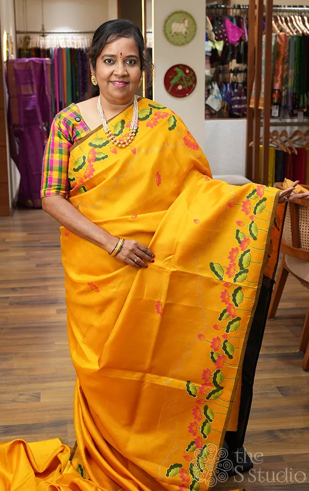 Mustard kanchipuram silk saree with hand painted pichwai and a black pallu
