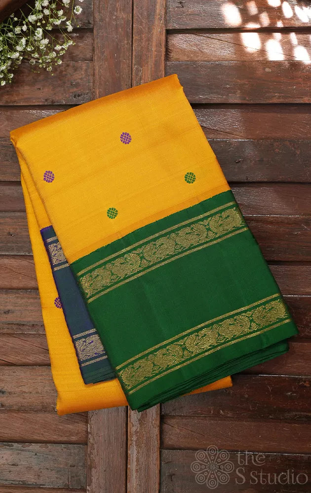 Mustard korvai kanjivaram silk saree with peacock blue and green border