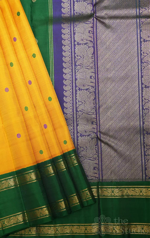 Mustard korvai kanjivaram silk saree with peacock blue and green border