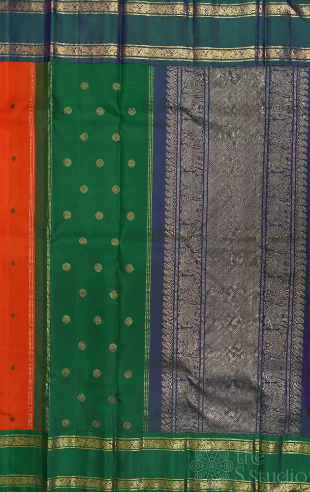 Orange korvai kanchi pattu saree with peacock blue and green border