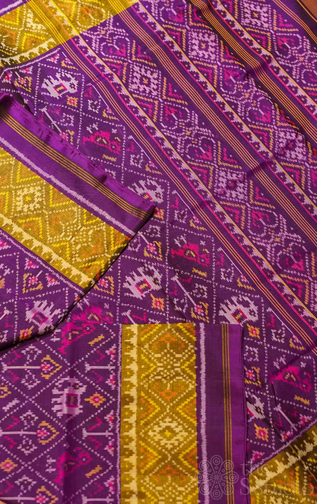 Purple rajkot patola saree with all over ikat design and tissue border