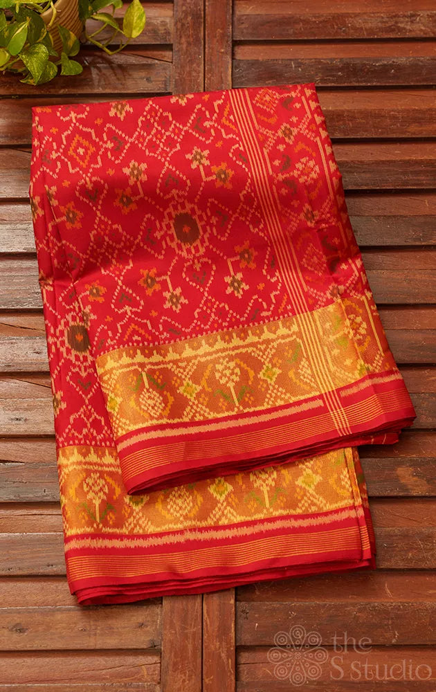 Red patola silk saree with all over ikat design and tissue border