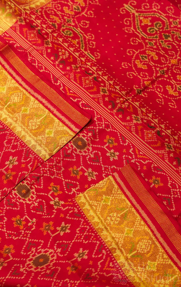 Red patola silk saree with all over ikat design and tissue border