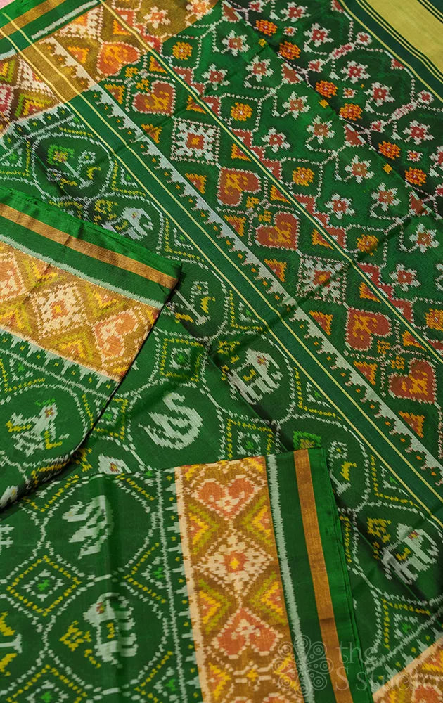 Green rajkot patola saree with all over ikkat design and tissue border