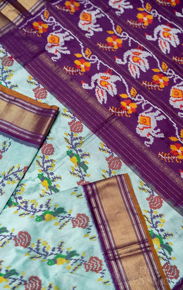 Pale green ikkat silk saree with contrast purple zari border