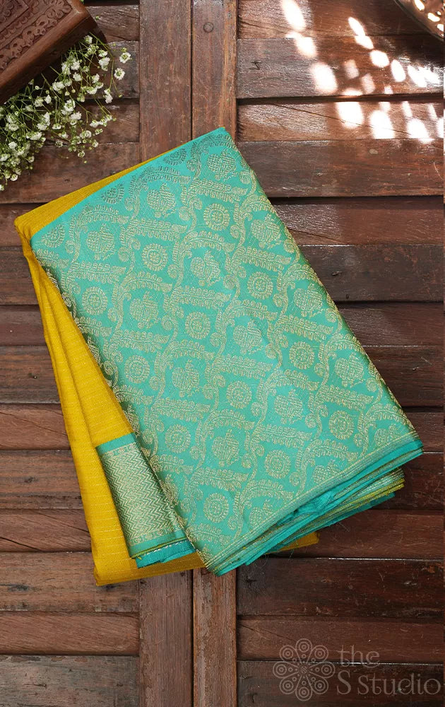 Yellow kanchi pattu saree with sea green zari woven long border