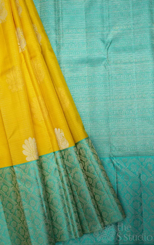 Yellow kanchi pattu saree with sea green zari woven long border