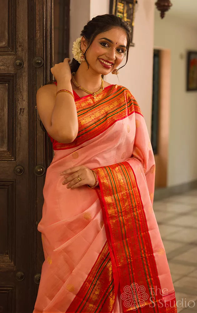 Light peach kanchi silk saree with ganda berunda motifs and korvai red borde