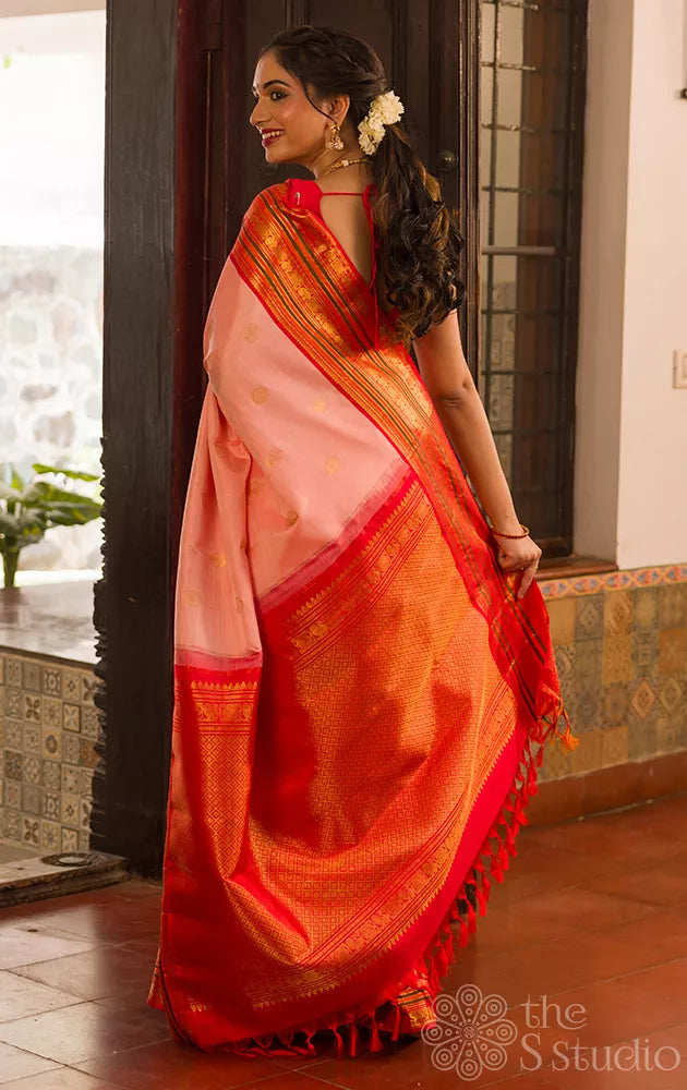 Light peach kanchi silk saree with ganda berunda motifs and korvai red borde
